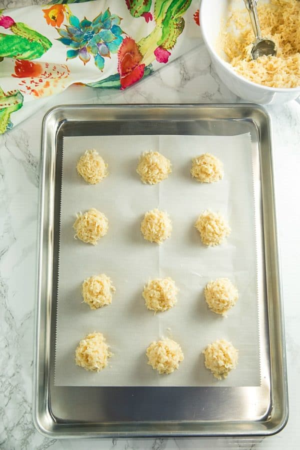 coconut macaroons on a sheet pan ready to be baked in the oven