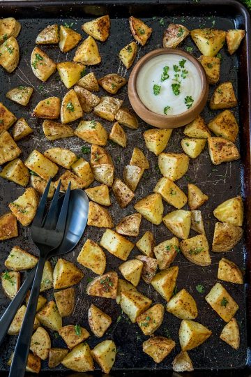 Oven Roasted Garlic Potatoes - crispy on the outside and fluffy inside. The garlic and spices add delicious savory flavor with every bite.#mustlovehomecooking #ovenpotatoes