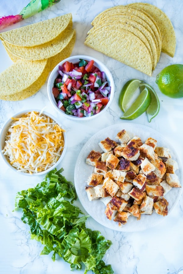 Lime Marinated Chicken Tacos are grilled, fresh lime marinated chicken breasts stuffed into crunchy taco shells and loaded with your favorite toppings. #mustlovehomecooking #mexicanfood #tacorecipes