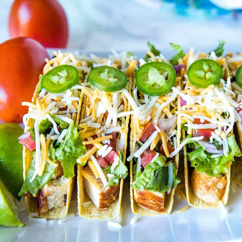 Lime Marinated Chicken Tacos are grilled, fresh lime marinated chicken breasts stuffed into crunchy taco shells and loaded with your favorite toppings. #mustlovehomecooking #mexicanfood #tacorecipes