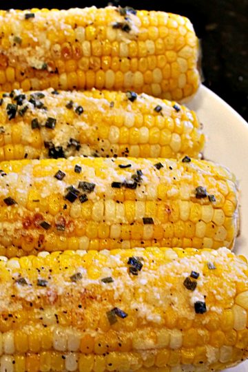 Fresh and crunchy, oven Parmesan Chive Corn on the Cob is the classic side dish recipe made hot and buttery for your next barbecue. #mustlovehomecooking