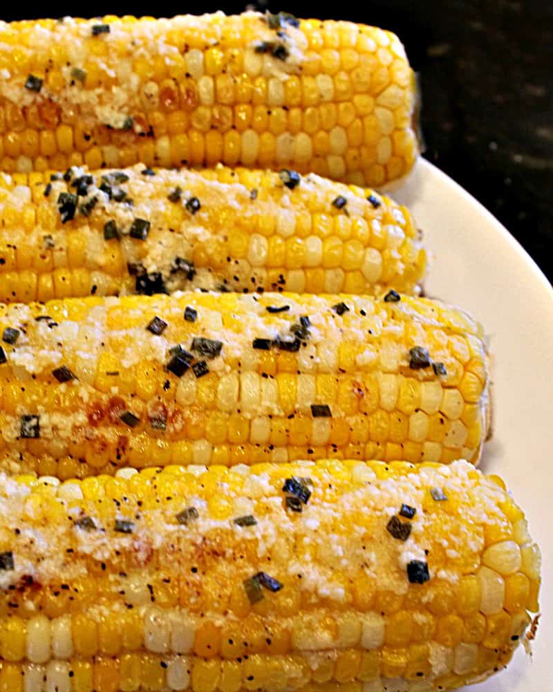 Fresh and crunchy, oven Parmesan Chive Corn on the Cob is the classic side dish recipe made hot and buttery for your next barbecue. #mustlovehomecooking