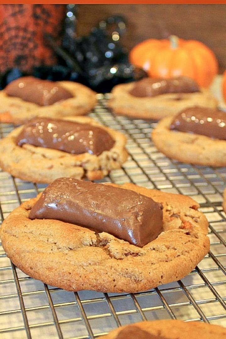 Butterfinger Ghoul Cookies are a tasty peanut butter and candy cookie treat! Cookies decorated for Halloween night, with ghoulish candy faces! Bake a batch to get the entire family in the Halloween spirit!