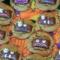 Butterfinger Ghoul Cookies are a tasty peanut butter and candy cookie treat! Cookies decorated for Halloween night, with ghoulish candy faces! Bake a batch to get the entire family in the Halloween spirit!