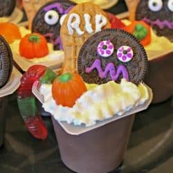 chocolate pudding cup decorated for Halloween with cookies and candies