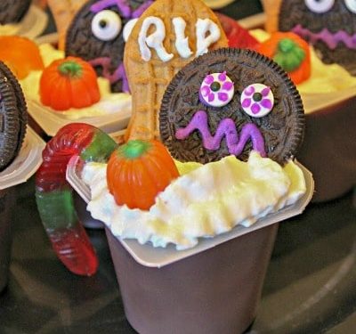 chocolate pudding cup decorated for Halloween with cookies and candies