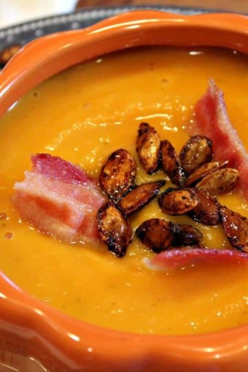 Warm and creamy, Roasted Butternut Squash Soup is comfort in a bowl. Rich oven-roasted squash, apples and onions are the base for this easy fall soup - so elegant when served in pumpkin bowls!