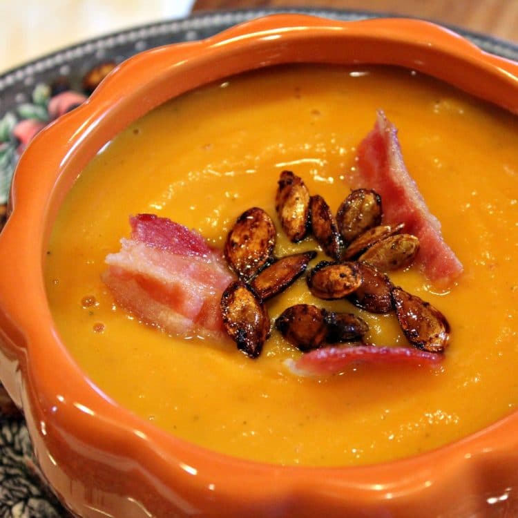 Warm and creamy, Roasted Butternut Squash Soup is comfort in a bowl. Rich oven-roasted squash, apples and onions are the base for this easy fall soup - so elegant when served in pumpkin bowls!
