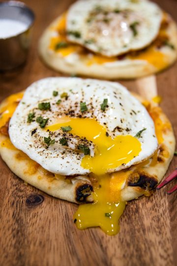 Naan Bread Breakfast Pizza with cream cheese, chives, bacon and cheese is totally delicious and an easy crowd favorite! It's ready in 10 minutes! #mustlovehomecooking