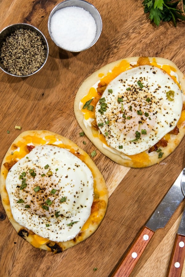 Naan Bread Breakfast Pizza with cream cheese, chives, bacon and cheese is totally delicious and an easy crowd favorite! It's ready in 10 minutes! #mustlovehomecooking