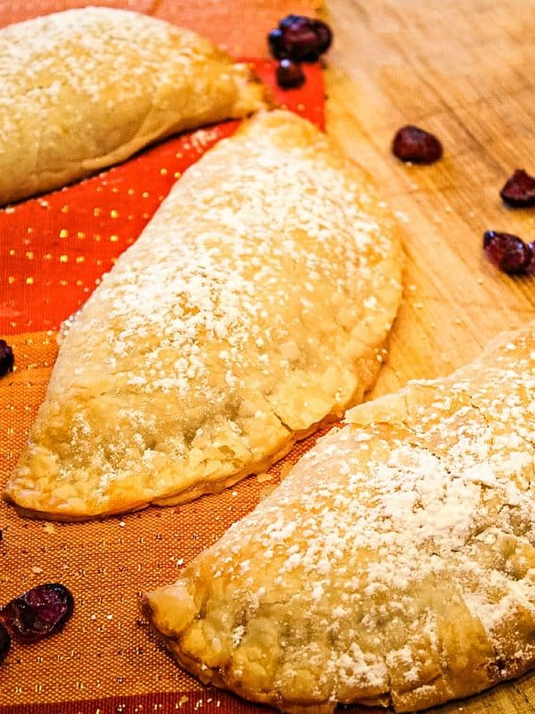 Apple Cranberry Pocket Pies are apple pie filling mixed with tart dried cranberries, baked in refrigerated pie dough.