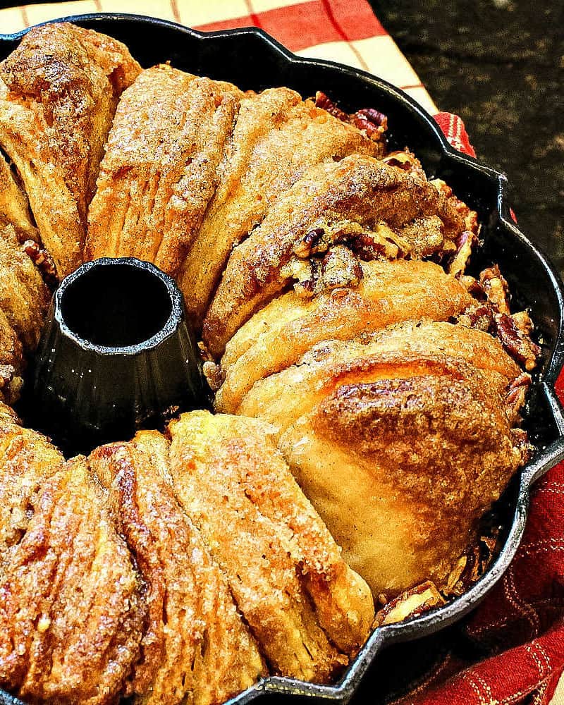 Cinnamon Walnut Monkey Bread is a maple sweet pan of pull-apart biscuits dripping with buttery caramel and toasty nuts. Deliciously easy to make and perfect for make-ahead and freezing! #mustlovehomecooking