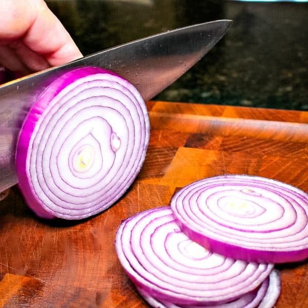 slicing red onion into rings