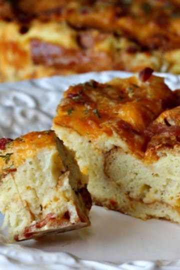 Cheddar Bacon Strata is a savory bread pudding/cake made with just 5 ingredients. Eggs, Bacon, cheese, bread and milk are what you need to make this delicious and gorgeous Strata. The Strata can be made a day ahead of time too! Click over for the complete recipe and easy instructions.