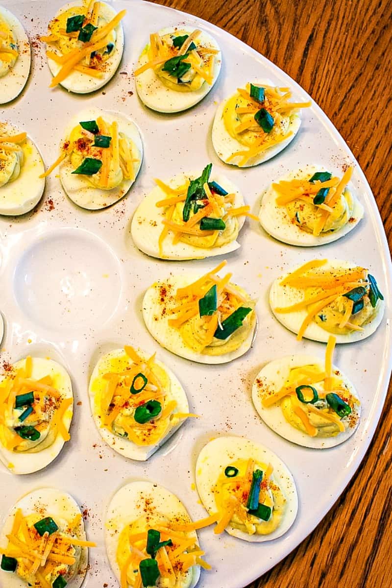 Tex Mex Spicy Deviled Eggs. It's a twist on the classic recipe with cheddar cheese, jalapeno, and chipotle pepper spice. South of the Border never tasted so good! #mustlovehomecooking
