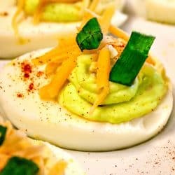 Tex Mex Spicy Deviled Eggs. It's a twist on the classic recipe with cheddar cheese, jalapeno, and chipotle pepper spice. South of the Border never tasted so good! Mustlovehomecooking