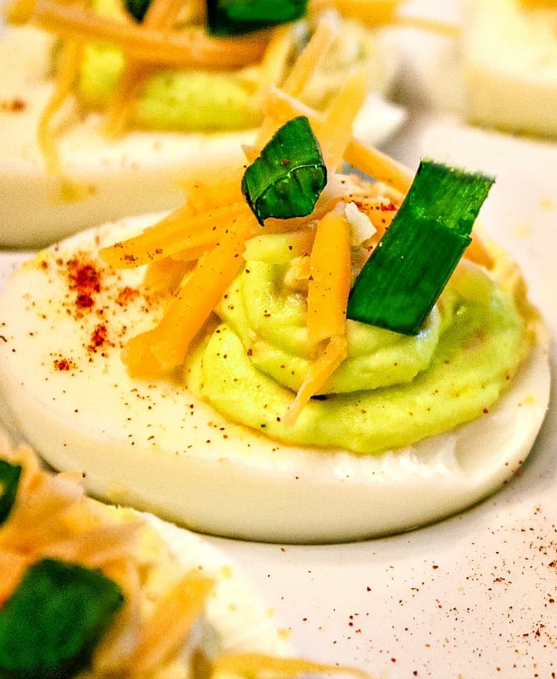 Tex Mex Spicy Deviled Eggs. It's a twist on the classic recipe with cheddar cheese, jalapeno, and chipotle pepper spice. South of the Border never tasted so good! Mustlovehomecooking