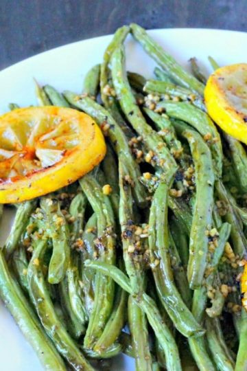 Oven Roasted Green Beans are easy peasy to make. Toss on a baking pan with olive oil, salt and pepper then pop in the oven. The Green beans come out with a yummy smokey flavor that will have you roasting all of your vegetables!