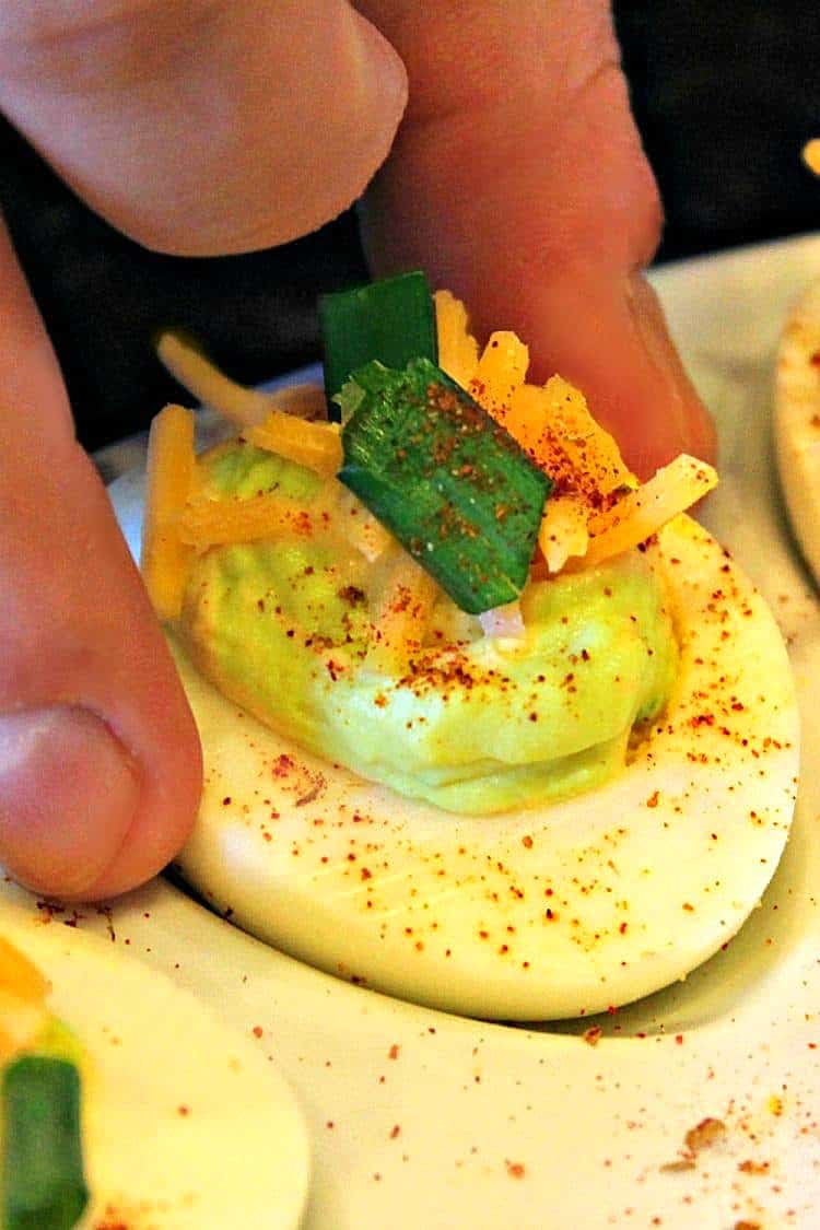 Tex Mex Spicy Deviled Eggs. It's a twist on the classic recipe with cheddar cheese, jalapeno, and chipotle pepper spice. South of the Border never tasted so good!