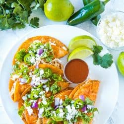 Chicken Street Enchiladas are corn tortillas dipped in thick enchilada sauce then filled with chicken and queso fresco, served folded over like a taco. Easy to make and fun to eat. #mustlovehomecooking #streetenchilada #mexicanfood