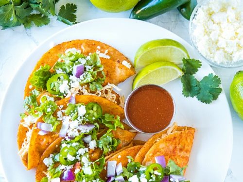 Chicken Street Enchiladas are corn tortillas dipped in thick enchilada sauce then filled with chicken and queso fresco, served folded over like a taco. Easy to make and fun to eat. #mustlovehomecooking #streetenchilada #mexicanfood