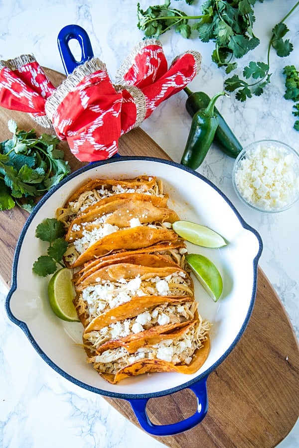 Chicken Street Enchiladas are corn tortillas dipped in thick enchilada sauce then filled with chicken and queso fresco, served folded over like a taco. Easy to make and fun to eat. #mustlovehomecooking #streetenchilada #mexicanfood