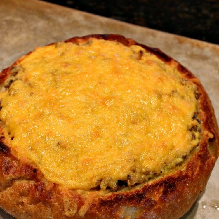 Sausage Egg Bowl - A crunchy Italian bread bowl filled with savory sausage, eggs, cheese and spices - perfect recipe to create a centerpiece dish for your next brunch or dinner!