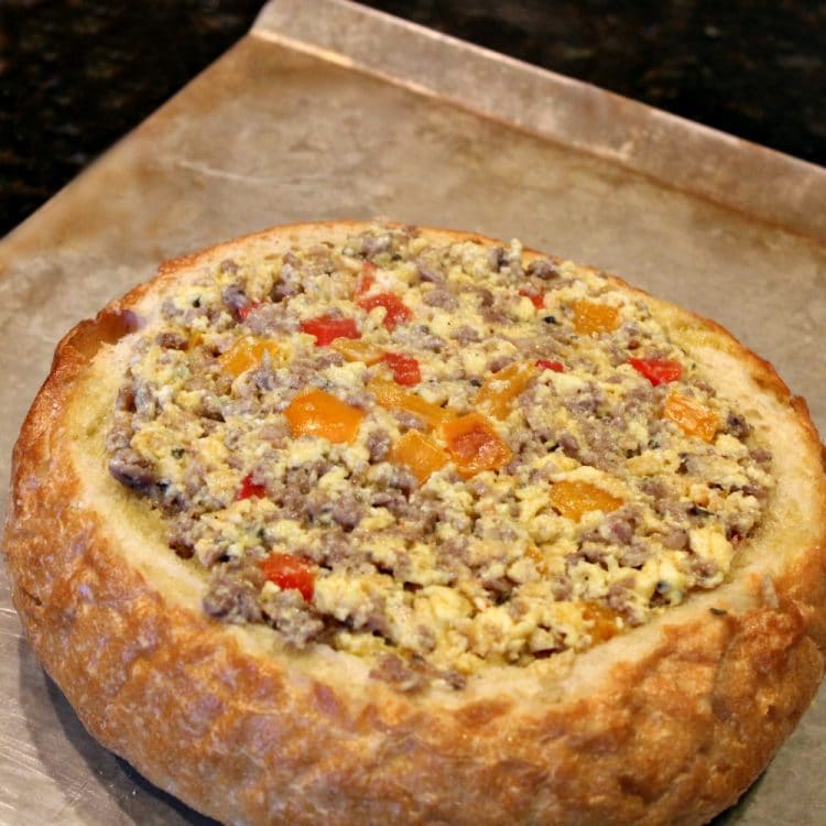 Sausage Egg Bowl - A crunchy Italian bread bowl filled with savory sausage, eggs, cheese and spices - perfect recipe to create a centerpiece dish for your next brunch or dinner!