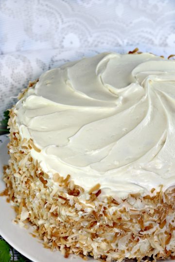 Loaded with carrots, pineapple,coconut,raisins and walnuts this ultimate Classic Carrot Cake Recipe is truly decadent. Finished with a thick layer of cream cheese frosting and toasted coconut makes this cake worthy of any special occasion.