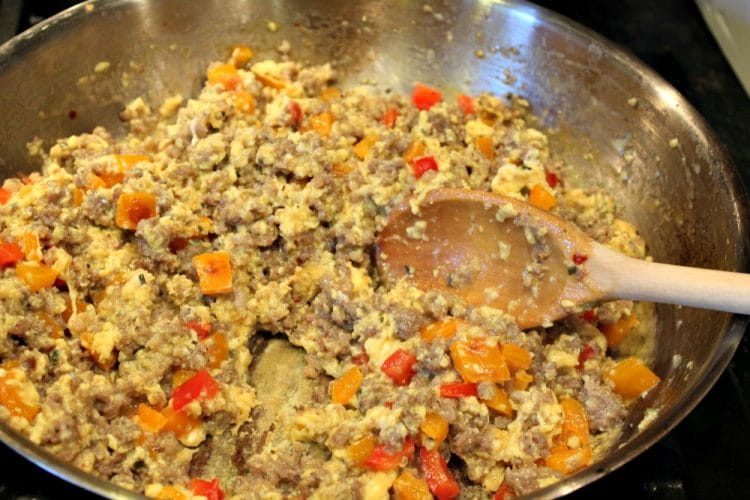 Sausage Egg Bowl - A crunchy Italian bread bowl filled with savory sausage, eggs, cheese and spices - perfect recipe to create a centerpiece dish for your next brunch or dinner!