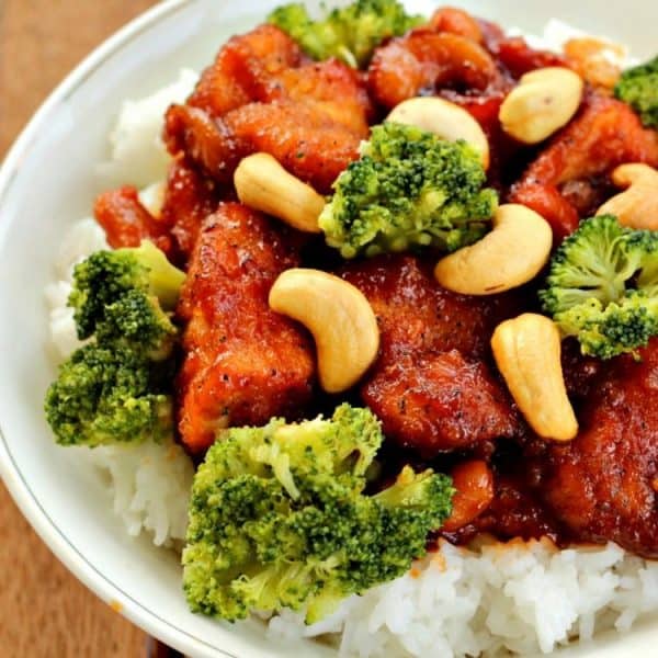 Put down that take-out menu! Slow Cooker Cashew Chicken - a zesty blend of chicken, cashews and a spicy sauce has your favorite fast food beat...hands down! Served with rice and broccoli it is a complete meal!