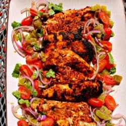 Harissa Chicken are grilled chicken breasts that have been marinated with a harissa rub of paprika, chipotle chilies, adobo sauce and cumin then served with a refreshing cilantro salad. Great alone or used as taco filling or the base for spicy chicken salad!