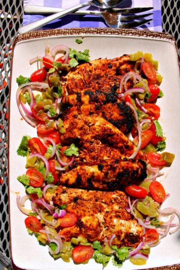 Harissa Chicken are grilled chicken breasts that have been marinated with a harissa rub of paprika, chipotle chilies, adobo sauce and cumin then served with a refreshing cilantro salad. Great alone or used as taco filling or the base for spicy chicken salad!