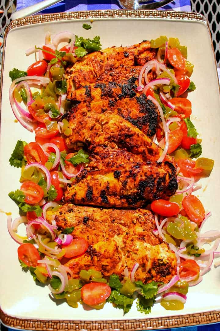 Harissa Chicken are grilled chicken breasts that have been marinated with a harissa rub of chipotle chilies, adobo sauce and spices then served with a refreshing cilantro salad.