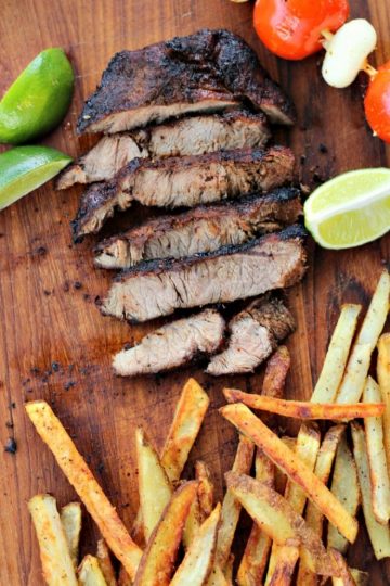 Marinated Southwest Flat Iron Steak - a melt in your mouth Flat Iron Steak that is grilled over high heat. A marinade including chili powder, brown sugar, and garlic is perfect for this cut of meat. Serve with an extra spritz of lime juice and fries!