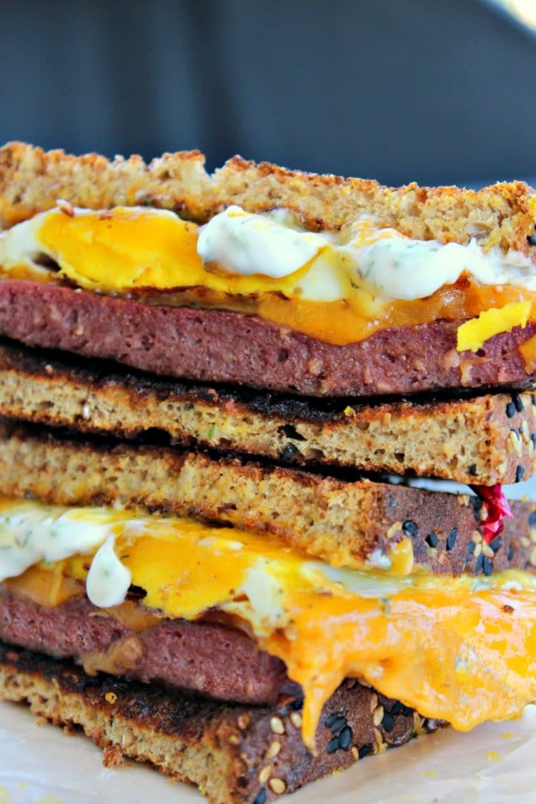 A Buckeye Breakfast Sandwich is a thick slab of Lebanon Bologna, aged cheddar cheese, and a fried egg served on toasted wheat bread that has been slathered with dill mayonnaise - a tasty family favorite and quick recipe that takes less than 10 minutes!