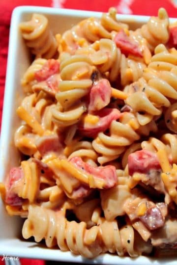 Cheddar Bacon Ranch Pasta Salad - a quick and easy combination of favorite flavors like bacon, cheddar cheese and ranch dressing tossed with pasta and BBQ sauce to create a cold side that will become your new go-to pasta salad dish! Great for picnics and potlucks too!
