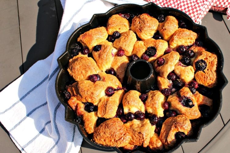 Blueberry Vanilla Monkey Bread is a delicious pull apart bundt loaf chock full of blueberries, smothered and baked in a syrup made from cinnamon, butter and vanilla. It is an amazing brunch dish that will also be a hit at any potluck or party!