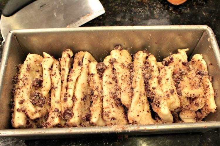 Chocolate Pumpkin Spice Pull Apart Bread is a soft, buttery loaf chock full of autumn flavors. Chocolate chips, pumpkin pie spice and frozen bread dough combine in this easy recipe that anyone can make.