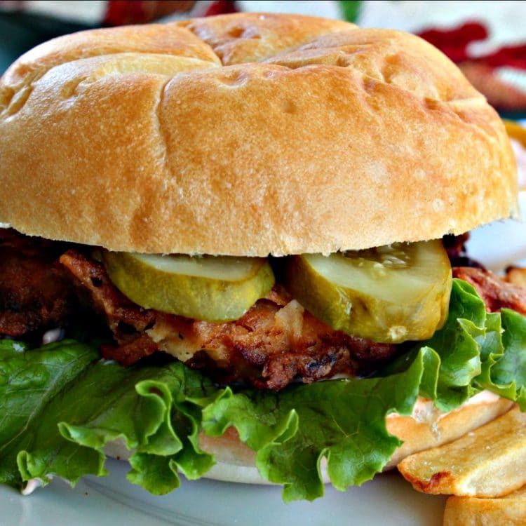 Spicy Fried Chicken Sandwich is a marinated chicken thigh that has been fried to golden and crunchy perfection. It is served on bun with a thick sliced pickle and slathered with buttermilk chili sauce. The secret is in the simple marinade, leaving the chicken moist with melt-in-your-mouth flavor.
