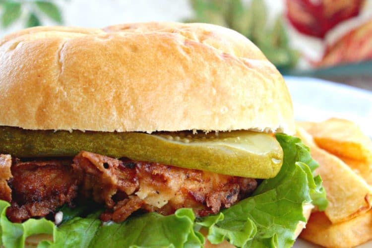 Spicy Fried Chicken Sandwich is a marinated chicken thigh that has been fried to golden and crunchy perfection. It is served on bun with a thick sliced pickle and slathered with buttermilk chili sauce. The secret is in the simple marinade, leaving the chicken moist with melt-in-your-mouth flavor.