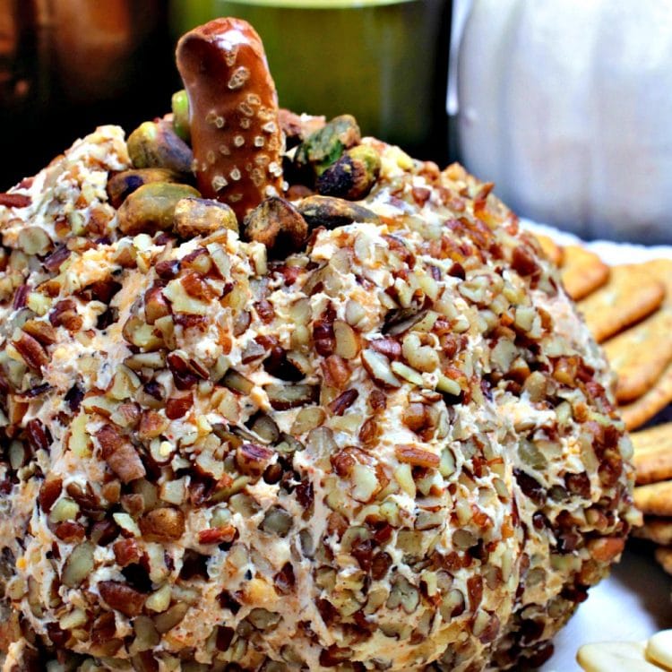 Pumpkin-Shaped Cheddar Cheese Ball - your guests will love the cute seasonal shape! There is no pumpkin in the recipe, the inside is savory smooth cheddar, cream cheese and spices. Great to eat right away and even better when made ahead!