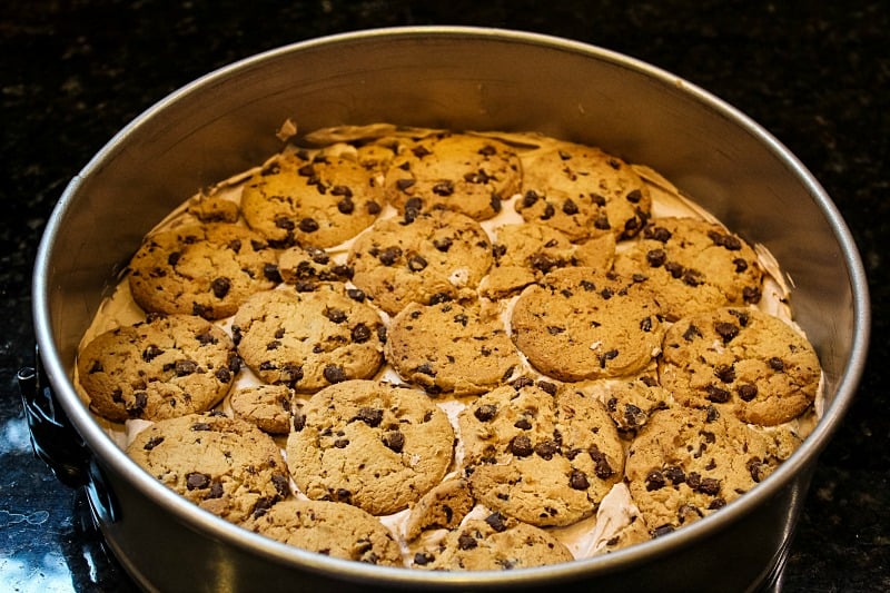 Velvety whipped cream filling and crunchy cookies makes this no-bake Chocolate Chip Cookie Ice Box cake the perfect dessert for all your special occasions. #mustlovehomecooking