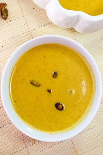 Harvest Pumpkin Soup is a creamy blend of pumpkin, broth and cream served warm with pistachios sprinkled on top