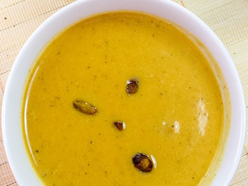Harvest Pumpkin Soup is a creamy blend of pumpkin, broth and cream served warm with pistachios sprinkled on top