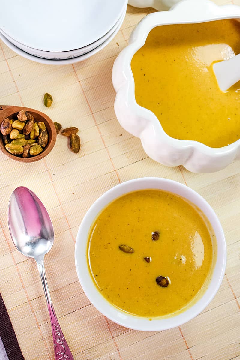 Harvest Pumpkin Soup is a creamy blend of pumpkin, broth and cream served warm with pistachios sprinkled on top. #mustlovehomecooking