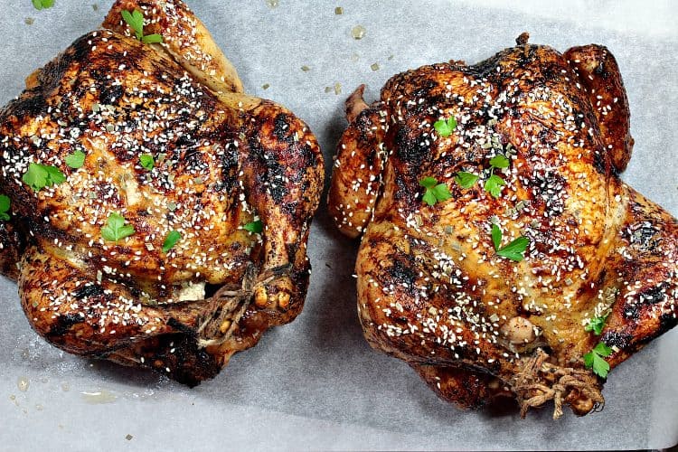 Sesame Honey Roasted Chicken is a moist, whole roasted chicken with a spiced soy and honey glaze. Finish with a dusting of toasted sesame seeds for extra crunch and flavor. This recipe makes two! Perfect to serve one now and reserve one for later.