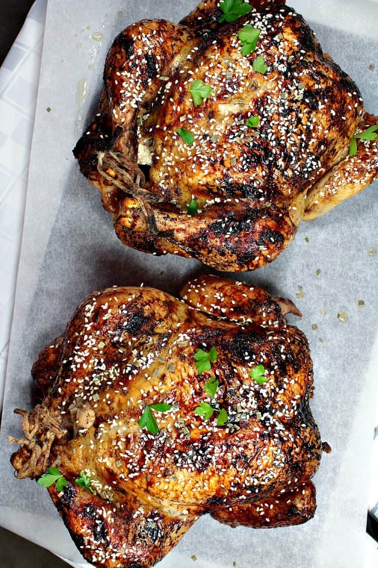 Sesame Honey Roasted Chicken is a moist, whole roasted chicken with a spiced soy and honey glaze. Finish with a dusting of toasted sesame seeds for extra crunch and flavor. This recipe makes two! Perfect to serve one now and reserve one for later.