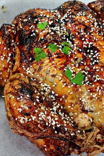 Sesame Honey Roasted Chicken is a moist, whole roasted chicken with a spiced soy and honey glaze. Finish with a dusting of toasted sesame seeds for extra crunch and flavor. This recipe makes two! Perfect to serve one now and reserve one for later.