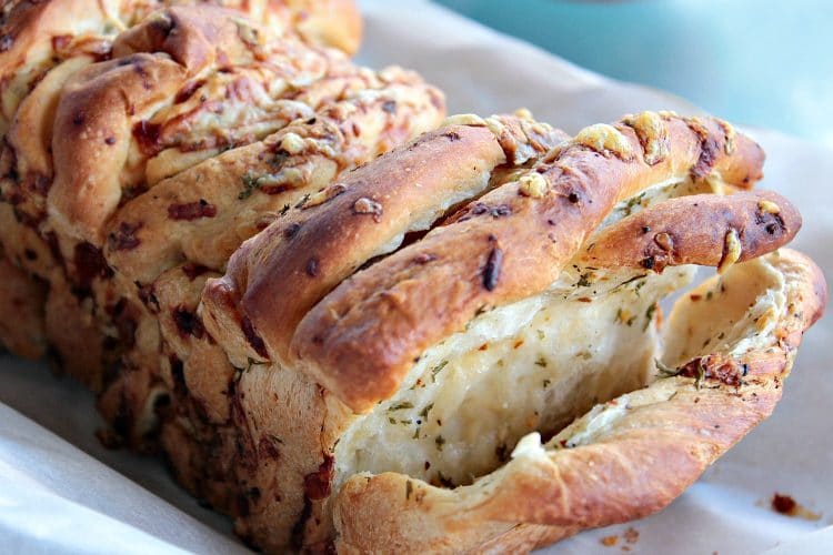 Garlic Parmesan Pull Apart Bread is a soft, buttery loaf loaded with flavor. It looks fancy but it could not be easier to make. No yeast or kneading to worry about because this recipe uses frozen bread dough!